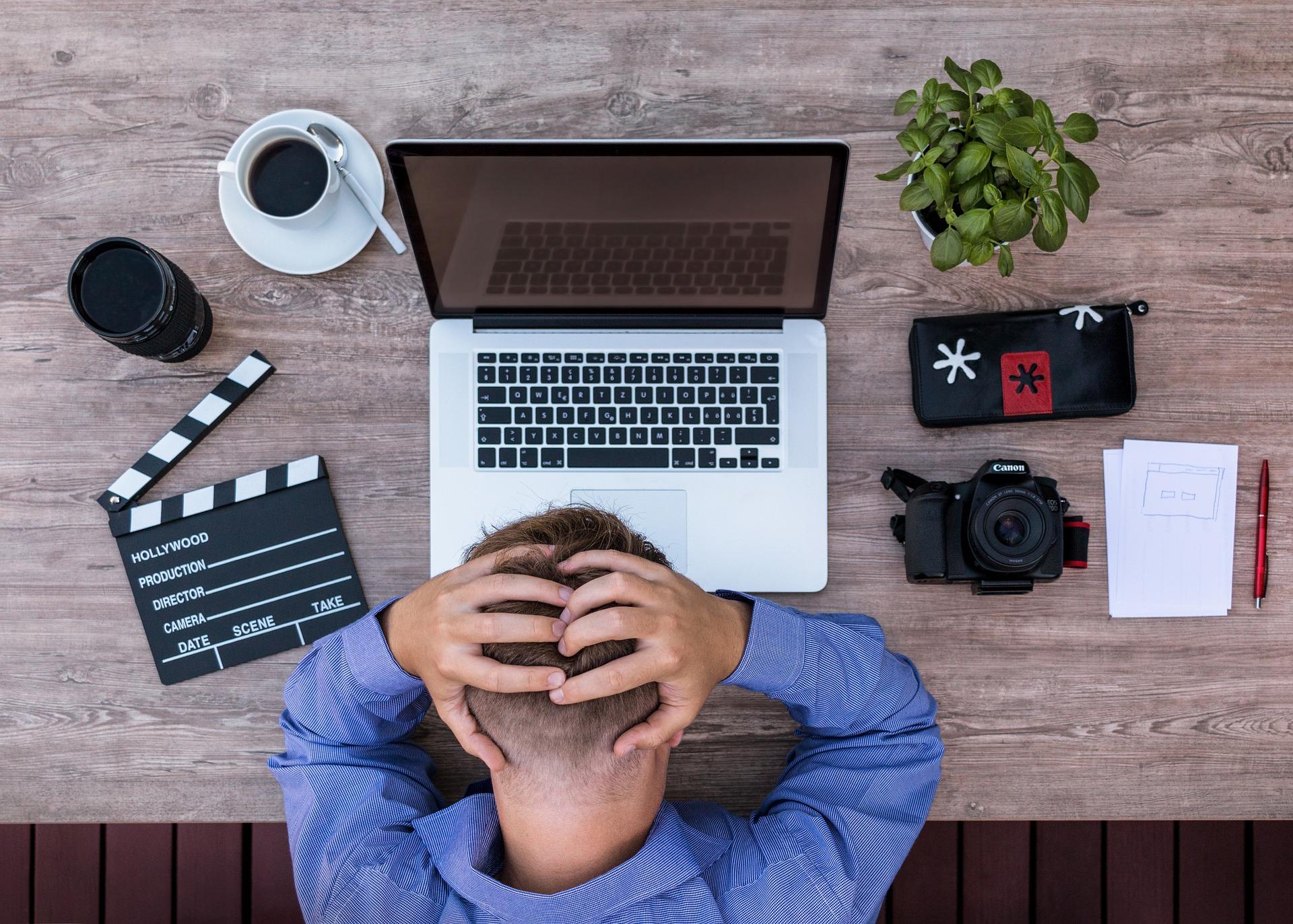 man holding his head in frustration